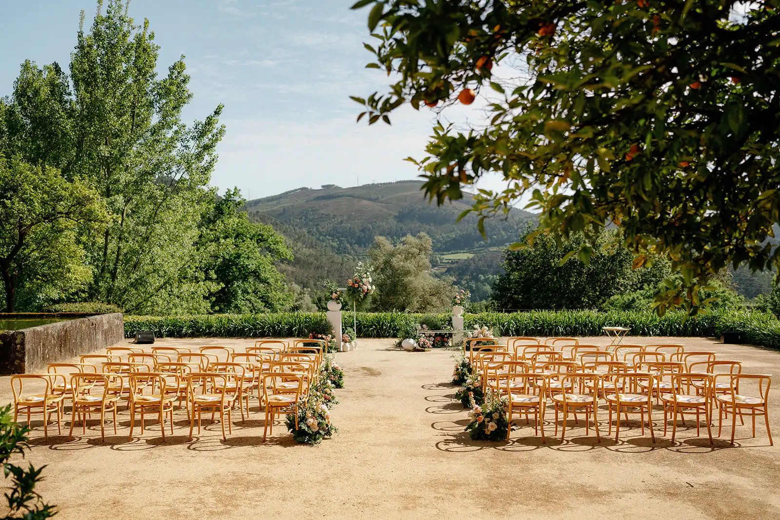 Wide-angle view of a garden wedding ceremony at the north of Portugal, in front at the beautiful Minho mountains.