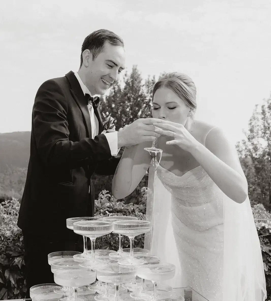 Champagne tower fun toast with bride and groom in black and white.