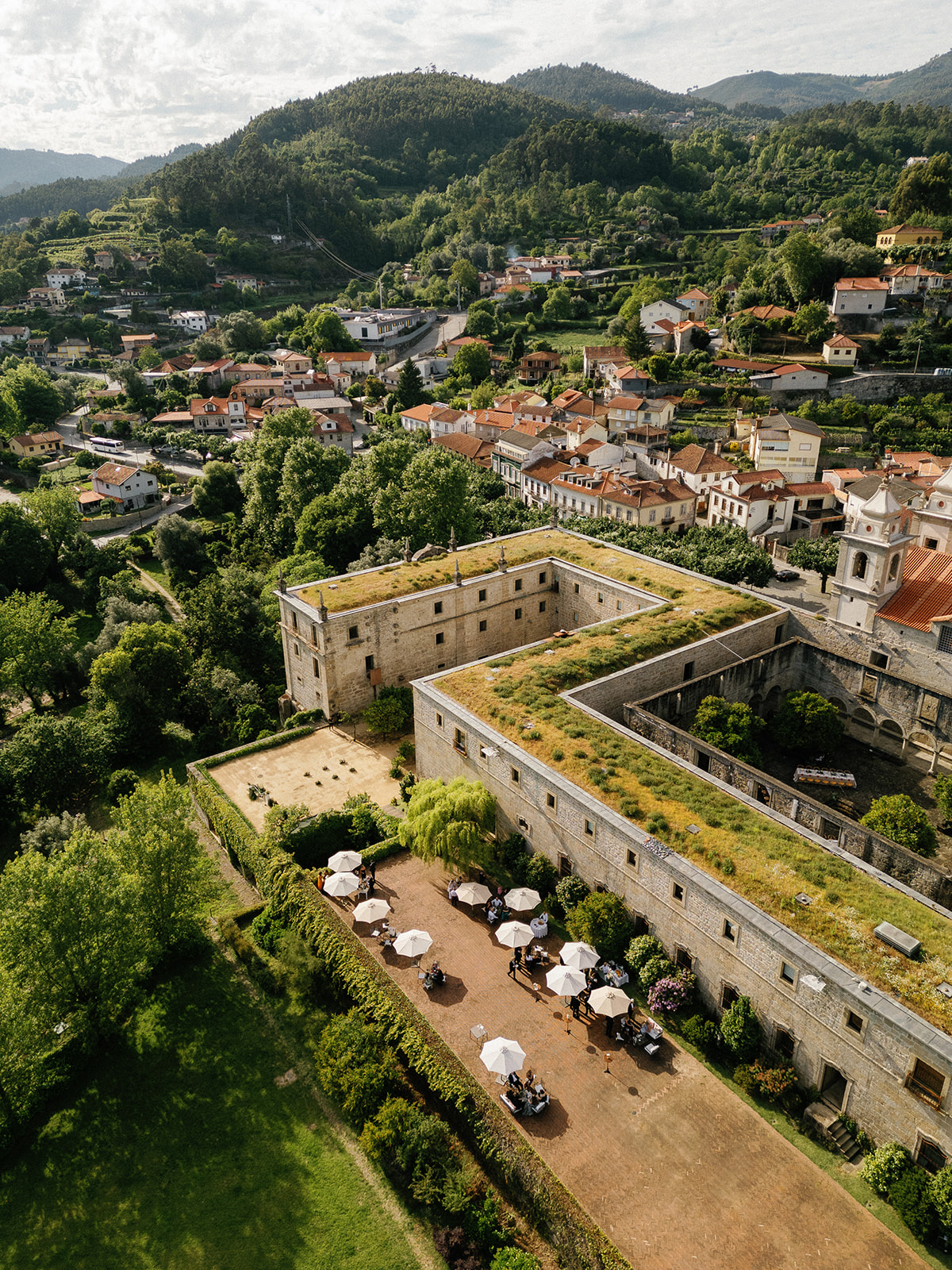 Aerial view from the Pousada Mosteiro de Amares surrounded by the Santa Maria do Bouro village aand the beautiful green mountains, in the north of Portugal. Wedding venue in Portugal, old centurie architecture.