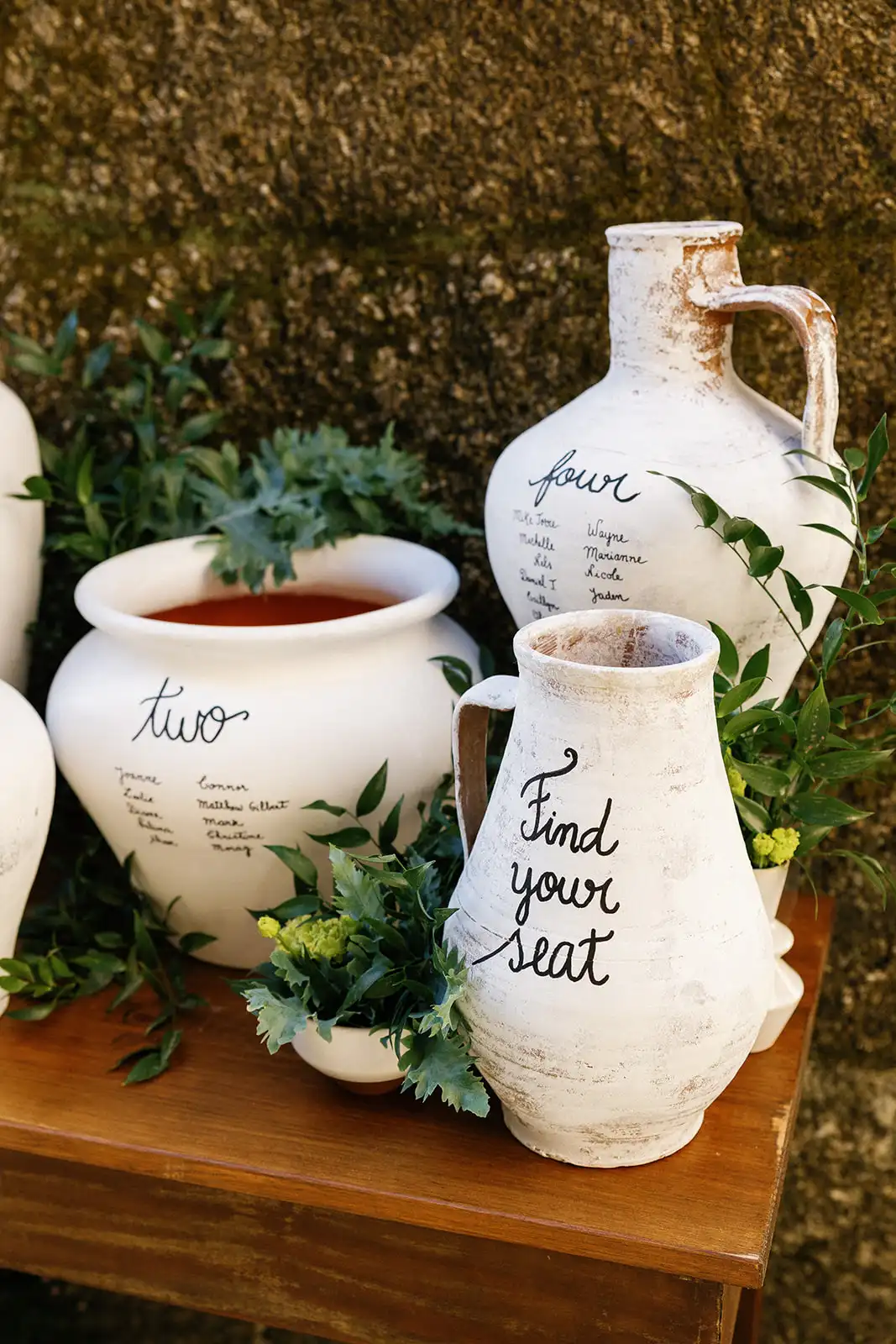 Seating plan table with old white vases and handwritting names.