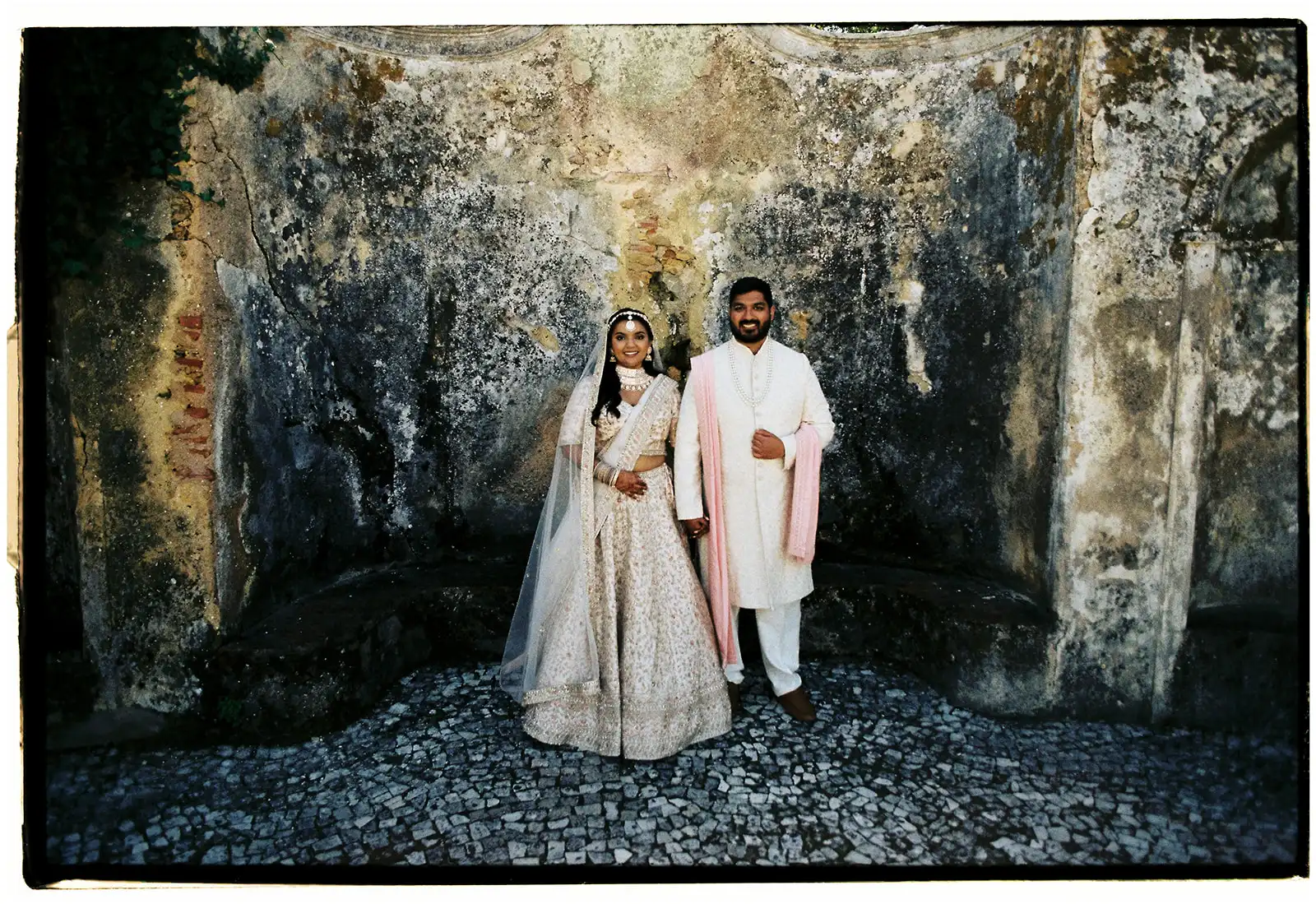 Indian bride and groom ready for the wedding ceremony in a historic country retreat in Portugal. Indian tradicional outfits in neutral colors.